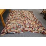 A large patchwork bed cover made up of batik style printed cotton, with blue reverseCondition