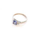 A tanzanite and diamond ring, stamped '18K', finger size P
