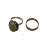 A closed set opal ring, stamped ‘18K’, finger size L; and a band ring, stamped ‘14K’, finger size