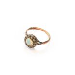 An opal and diamond cluster ring, unmarked, finger size NGross weight 2.6 grams.