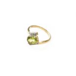 A 9 carat gold peridot and diamond ring, finger size NGross weight 2.4 grams.