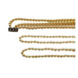 Two single row cultured pearl necklaces, length 72cm and 88cm approximately; and a three row