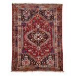 Kashgai Rug South West Iran, circa 1980 The raspberry field of tribal motifs centred by a