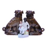 A pair of Victorian Bo'ness pottery models of seated Pug dogs; together with a Staffordshire group