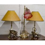 An early 20th century brass rise and fall lamp with cranberry tinted shade, 51cm