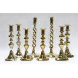 Five pairs of brass candlesticks including open twist and 19th century examples