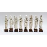 A set of eight 19th century Chinese carved ivory figures of immortals, each raised on a hardwood