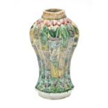 A Chinese Porcelain Vase, Kangxi, of fluted oval section baluster form, painted in famille verte