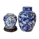 A 19th Century Chinese Kangxi style prunus blossom jar and cover, another blue and white ginger jar,