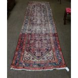A pair of Persian wool runners with foliate design and blue border (faded), 370cm by 105cm