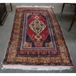 An Anatolian rug, the raspberry field with ivory medallion, enclosed by peach borders and
