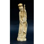 A Japanese Meiji period carved ivory okimono of a Shamisen player, 25cm high