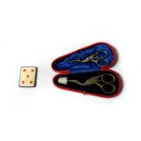 Two pairs of stork sewing scissors with a thimble in fitted case; a playing card pin cushion