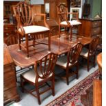 A modern Regency style mahogany set of eight dining chairs with shield backs, including two carvers,