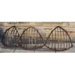 Three Victorian iron hay racks (two a.f.), approximately 95cm by 76cm