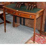 An Edwardian cross banded mahogany writing table, on castors, 71.5cm by 92cm by 49cmSome bubbling to