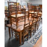 A set of eight oak ladderback dining chairs, including two carvers, retailed by I & JL Brown,