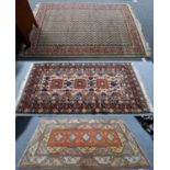 An Indian rug, the ivory field of boteh enclosed by candy pink borders, 183cm by 119cm, together