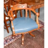 An early 20th century carved oak swivel chair