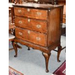 An 18th Century Walnut and Feather Banded Chest, with three graduated long drawers, raised on a