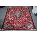 Mashad rug, the raspberry field of vines around a central medallion, framed by spandrels and