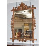 A 19th century gilt-framed mirror applied with foliate swags, 78cm by 115cm