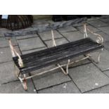 A garden bench with painted wrought iron scrolling ends and wooden slats, painted white, 154cm wide