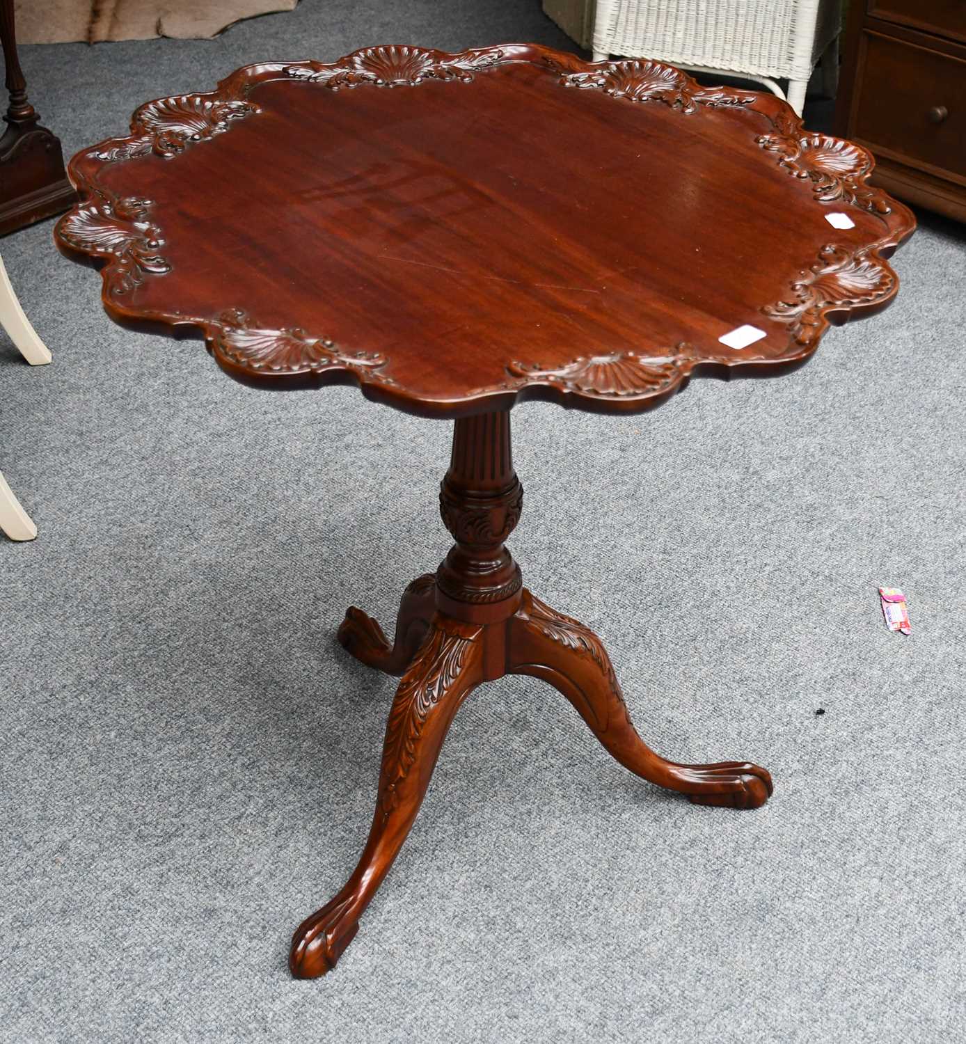 A reproduction George III style mahogany supper table with scalloped dish top carved with shells and