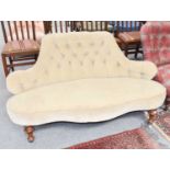 A 19thcentury small parlour sofa with buttoned cream upholstery and carved mahogany frame