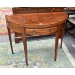 A George III string inlaid mahogany demi lune foldover tea table on tapering square section legs,