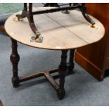 An oak corner table, with circular drop leaf top composed of period elements, together with a