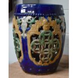 A Chinese earthen ware garden stool of barrel form, with openwork side panels, beaded moulding and