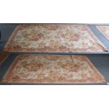 A pair of machine made rugs, each of naturalistic floral design, 297cm by 170cm (2)