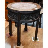 A Chinese late 19th / early 20th century carved hardwood occasional table with marble inset top,