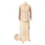 A 19th Century Cream Silk Two Piece Costume, comprising a fitted jacket with a shaped front and