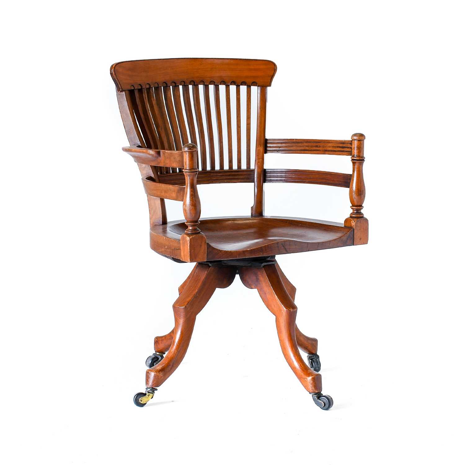 An Aesthetic Movement Walnut Office Swivel Chair, designed by E.W.Godwin, slatted back, shaped arms,