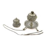 An Omani Incense-Burner With Tongs, the burner globular and with hinged openwork cover, with foliage