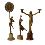 An Art Deco figural spelter time piece formed as a dancing girl, raised on a white onyx base;