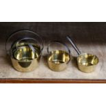 A collection of 19th century brass pans to include a small saucepan and four with loop handels (