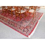 A Mashad carpet, the raspberry field of vines around flower head medallion framed by spandrels and