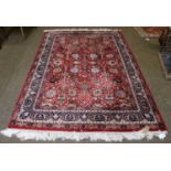 Indian Rug, The brick-red field of Shah Abbas, design enclosed by Indigo borders 250cm by 131cm