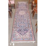 A narrow Hamadan runner, the indigo Herati field with ivory medallion framed by narrow borders,