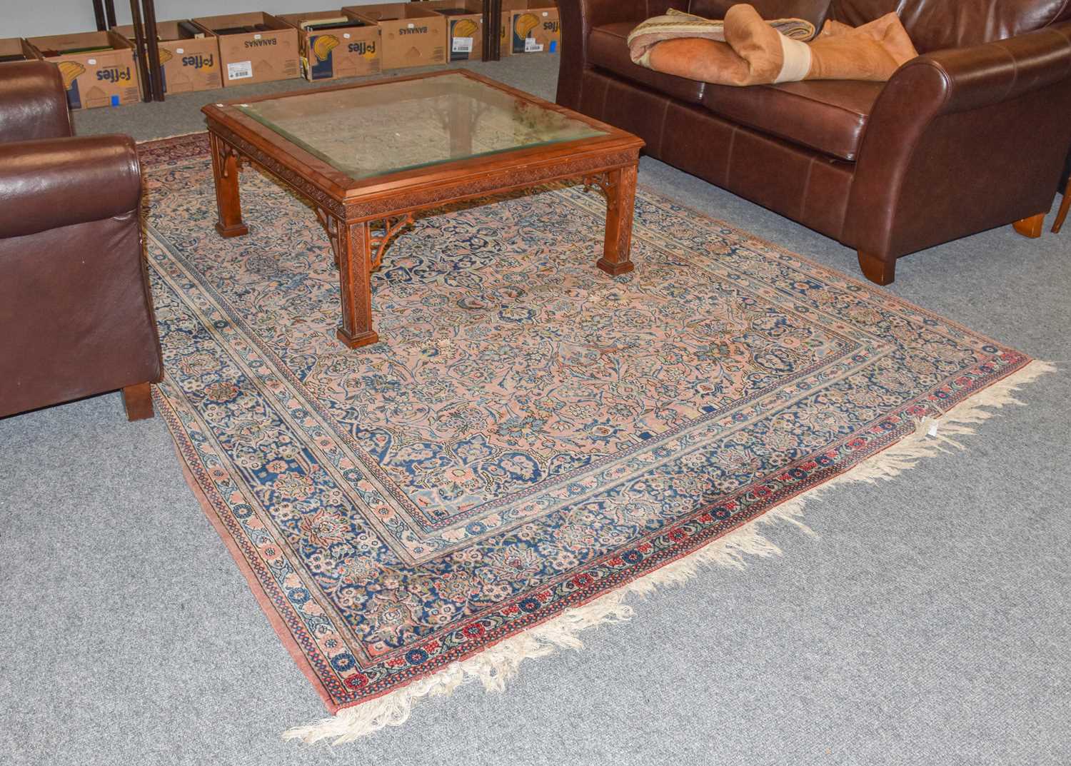 A Kashan carpet, the field profusely decorated with palmettes and vines around an indigo medallion