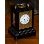 An ebonised striking mantel clock, circa 1850, carrying handle, glazed side panels, enamel dial with