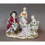 A Meissen figure group, 19th century, Cupid in Disguise, modelled seated with three ladies by his