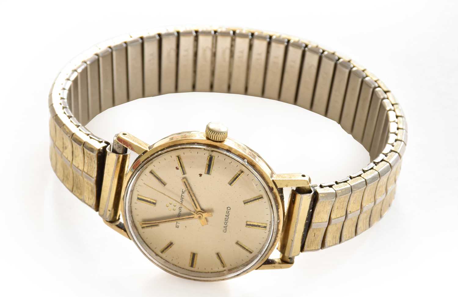 A 9-carat gold automatic centre seconds wristwatch, signed Eterna-Matic, retailed by Garrard