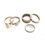 A 9 carat gold band ring, finger size M1/2; a 9 carat gold eternity ring, finger size O; a band ring