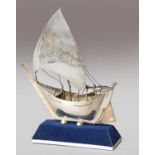 A silver model of a boat stamped silver 925, 26cm highThe rudder is functioning. Highest point of