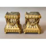 A pair of 19th-century carved and giltwood vase stands decorated with acanthus leaves and floral
