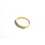 An 18 carat gold diamond seven stone ring, finger size P1/2Gross weight 3.9 grams.